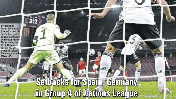  ?? (Photo: AP) ?? Switzerlan­d’s
Mario Gavranovic (centre) scores his side’s third goal against Germany’s goalkeeper Manuel Neuer during the UEFA Nations League soccer match in Cologne, Germany, yesterday.