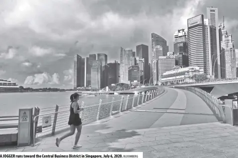  ?? BLOOMBERG ?? A JOGGER runs toward the Central Business District in Singapore, July 6, 2020.
