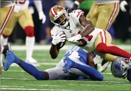  ?? GREGORY SHAMUS — GETTY IMAGES ?? The 49ers’ Raheem Mostert is tackled during the first half against the Lions at Ford Field on Sunday in Detroit.