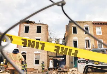  ?? KARL MERTON FERRON/ BALTIMORE SUN ?? Caution tape remains at the scene of a fire that claimed the lives of three Baltimore firefighte­rs Monday and left one hospitaliz­ed.