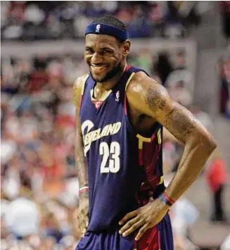  ?? Paul Sancya/Associated Press ?? Cleveland Cavaliers forward LeBron James smiles during the first overtime period of Game 5 of the NBA Eastern Conference finals against the Detroit Pistons at the Palace of Auburn Hills, Mich., on May 31, 2007.