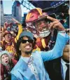  ?? PAUL SANCYA/AP ?? LSU quarterbac­k Jayden Daniels celebrates with fans after being chosen by the Commanders with the second overall pick during the first round of the NFL draft Thursday.