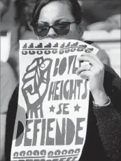  ??  ?? A PROTESTER attends the news conference to demonstrat­e against gentrifica­tion in Boyle Heights.