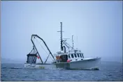  ?? ROBERT F. BUKATY — THE ASSOCIATED PRESS FILE ?? A scallop fishermen heads out at dawn day off Harpswell, Maine.