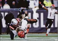  ?? Winslow Townson / Getty Images ?? The Patriots’ Devin McCourty tackles the Bengals’ Trenton Irwin during the first quarter on Dec. 24 in Foxborough, Mass.