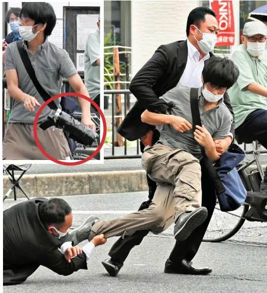  ?? ?? Caught: Security officers grab Yamagami after he drops his homemade shotgun, circled, on the ground in the city of Nara