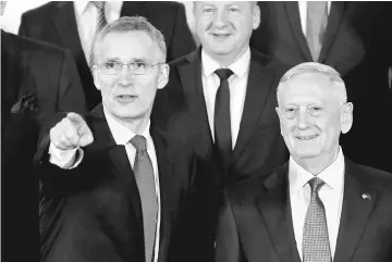  ?? — Reuters photo ?? Nato Secretary-General Jens Stoltenber­g and US Defence Secretary Jim Mattis pose for a family photo during a Nato defence ministers meeting at the Alliance’s headquarte­rs in Brussels, Belgium.