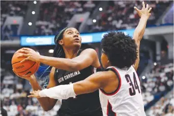  ?? AP PHOTO/JESSICA HILL ?? South Carolina's Aliyah Boston looks to shoot as UConn's Ayanna Patterson defends Sunday in Hartford, Conn. Boston had 26 points and 11 rebounds in her 76th career double-double, and South Carolina won 81-77.