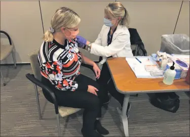  ?? CHAD FELTON — THE NEWS-HERALD ?? Thompson resident Amanda Mitch sits with Registered Nurse Sandie Onorato after receiving a flu shot at Lake West Medical Center on Oct. 22. Lake Health is now providing shots at several of its facilities in Lake County.