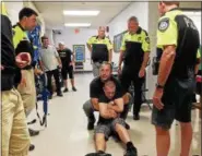  ?? DIGITAL FIRST MEDIA FILE PHOTO ?? Lansdale police Sgt. Ryan Devlin, center, demonstrat­es how to lift and carry an injured person during tactical training for a school shooting scenario.