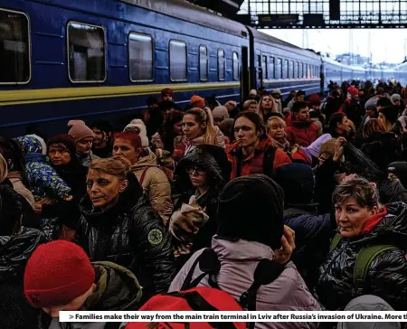  ?? ?? > Families make their way from the main train terminal in Lviv after Russia’s invasion of Ukraine. More than 5.6 million refugees have since left the country, while an estimated 7.7 million people have been displaced