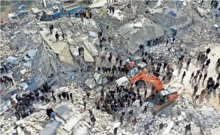  ?? OMAR HAJ KADOUR/AFP VIA GETTY IMAGES ?? Residents and workers with heavy equipment search flattened buildings for survivors in Besnia, Syria, near the Turkish border Monday after a 7.8 magnitude earthquake struck at 4:17 a.m. local time.