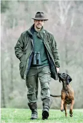  ??  ?? Dirk Gratzel walks with his dog at his hunting ground. — IC