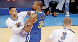  ?? [PHOTO BY BRYAN TERRY, THE OKLAHOMAN ARCHIVES] ?? Golden State’s Kevin Durant, center, and Oklahoma City’s Russell Westbrook, left, say Wednesday night’s game at Chesapeake Energy Arena is just another game.