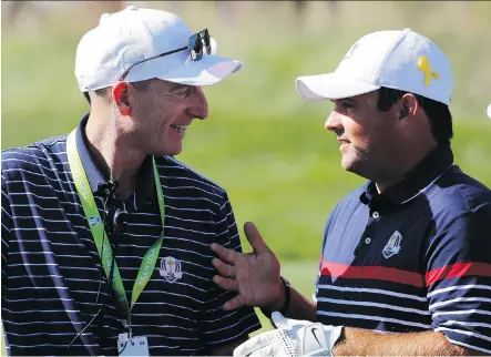  ?? FRANCOIS MORI/THE ASSOCIATED PRESS ?? U.S. captain Jim Furyk chats with Patrick Reed during a practice session on Thursday leading up to the Ryder Cup playdowns at Le Golf National in Saint-Quentin-en-Yvelines, France. Reed will be paired with his hero Tiger Woods in Friday’s opening round.