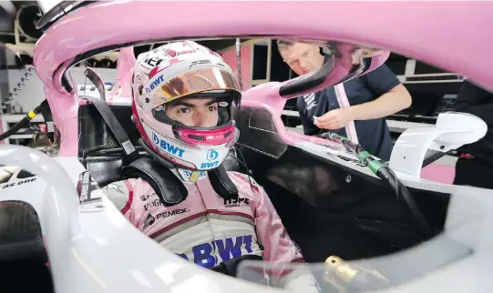  ?? TOM BOLAND/THE CANADIAN PRESS ?? Nicholas Latifi, from Toronto, is fitted for his seat Thursday in Montreal. The Force India reserve and test driver completed his first F1 practice on the Circuit Gilles Villeneuve on Friday morning. He finished 19th, 3.843 seconds behind the time of...