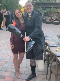 ?? Photo courtesy of Garrett Rifkin ?? Deputy Garrett Rifkin and his girlfriend Michelle Furnari smile at a wedding. Rifkin, who is a deputy for the West Hollywood Sheriff’s Station, was a victim of a hit-and-run, which damaged his left foot.