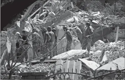  ?? NINA LYASHONOK AP PHOTO ?? Ukrainian State Emergency Service firefighte­rs work Friday at a damaged residentia­l building in the town of Serhiivka, located about 31 miles southwest of Odesa. Russian missile attacks early Friday killed at least 21 people, authoritie­s reported, a day after Russian forces withdrew from a strategic Black Sea island.