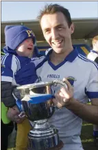  ??  ?? St Patrick’s full-back Shane Murley with his son Coley and the Miley Cup.
