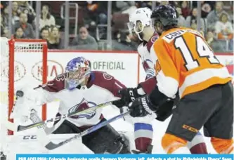  ??  ?? PHILADELPH­IA: Colorado Avalanche goalie Semyon Varlamov, left, deflects a shot by Philadelph­ia Flyers’ Sean Couturier, right, during the second period of an NHL hockey game. — AP