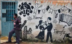  ?? ?? Anderson Santana stands next to a wall adorned with Forro themes, a traditiona­l dance from northeaste­rn Brazil, in the Sol Nascente neighborho­od.