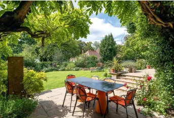  ??  ?? 1&3 PATIO
Orange detailing on the garden furniture is a playful touch.
Try the Kettler dining set, £519, Garden Furniture World. Fermob 1900 wrought-iron benches, £525 each, The Worm that Turned