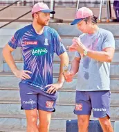  ?? — RR ?? Jos Buttler (left) of the Rajasthan Royals interacts with coach Kumar Sangakkara at a training session in Mumbai on Friday.