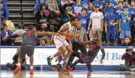  ?? DAVID JABLONSKI / STAFF ?? Dayton’s Jalen Crutcher takes a charge against Saint Louis guard Javon Bess on Tuesday at Chaifetz Arena in St. Louis.