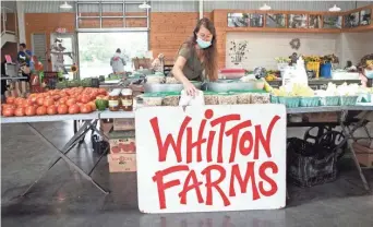  ?? ARIEL COBBERT/THE COMMERCIAL APPEAL ?? Jill Forrester of Whitton Farms works at her booth at the farmers market in Wilson, Ark., on Sept. 2.