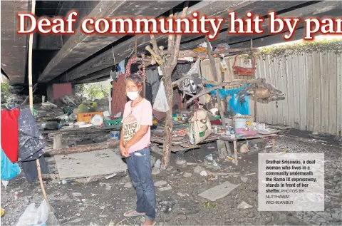  ??  ?? Orathai Srisawas, adeaf woman who lives in a community underneath the Rama IX expressway, stands in front of her shelter. PHOTOS BY NUTTHAWAT WICHIEANBU­T