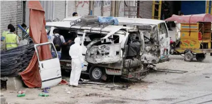  ??  ?? LAHORE: Pakistani investigat­ors examine damage vehicles at the site of suicide bombing in Lahore, Pakistan. — AP