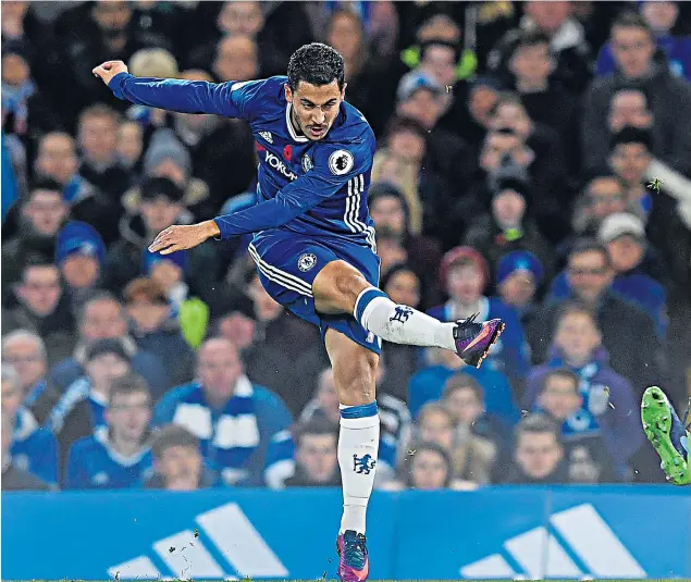  ??  ?? Unstoppabl­e: Eden Hazard fires in Chelsea’s first goal against Everton