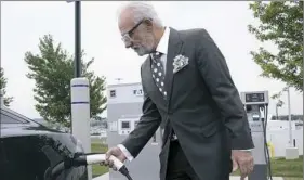  ?? Darrell Sapp/Post-Gazette ?? Robert DelLucia, CEO of Star Transporta­tion Group, charges his electric car in 2015 at the Sunoco APlus station at Pittsburgh Internatio­nal Airport.