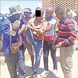  ?? (Pics: Themba Zwane) ?? One of the bus rank card gamblers being forcefully taken to the police station by transport operators.