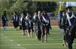  ?? JOEL ROSENBAUM — THE REPORTER ?? Members of the Muzetta Thrower Adult Education Center class of 2022march in procession during commenceme­nt ceremonies Wednesday at Will C. Wood High School.