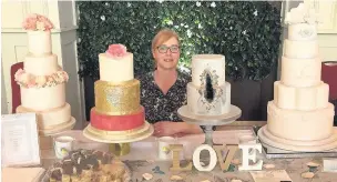  ??  ?? Yvonne with some of her tiered wedding cakes at a wedding fair