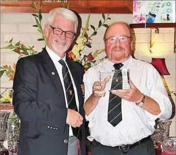  ??  ?? Coollattin Golf Club Captain Hugh Kane, presents his Captains Prize to the winner Tom Ryan.Tom recorded a one under par net 71 in the qualifying round the previous week, and kept his form for to have another 71 in The Captains day which got him back out for another Nine holes in the evening, with