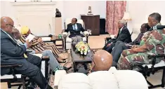  ??  ?? Robert Mugabe, centre, holds talks with senior military officers and African envoys. Harare, the capital, remained calm, with even the soldiers appearing relaxed, right