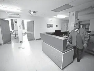  ?? ROGELIO V. SOLIS/THE ASSOCIATED PRESS ?? Alliance Healthcare System hospital Environmen­tal Service Manager Ardency Baird checks on empty hospital beds last month in one of the shut-down floors of the Holly Springs, Miss., facility. Rural emergency hospitals must close inpatient beds and provide 24/7 emergency care.