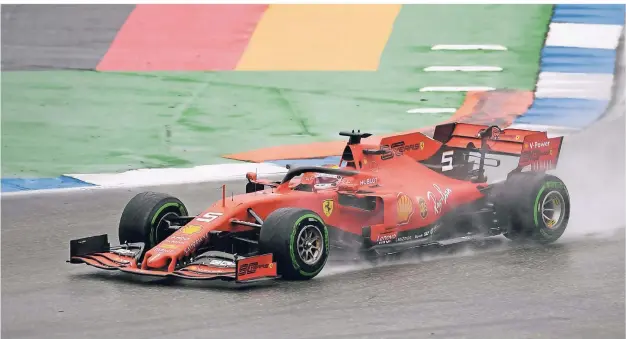  ?? FOTO: FABIAN SOMMER/DPA ?? Ferrari-Pilot Sebastian Vettel fährt beim Grand Prix von Deutschlan­d in einem spannenden Regen-Rennen von Rang 20 auf Rang Zwei.