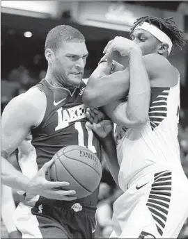  ?? Darron Cummings Associated Press ?? BROOK LOPEZ, who scored 23 for the Lakers including 13 points in the first quarter, battles the Indiana Pacers’ Myles Turner during the first half.