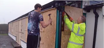  ??  ?? Getting ready for Hurricane Ophelia were Martin Galvin and his son Adam. Their seaside home at Lobster Cottage sits in Courtmacsh­erry Bay in Co Cork. Photo: Denis Boyle