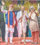  ??  ?? A woman takes selfie with artists dressed as PM Narendra Modi and Mahatma Gandhi at an event in Mumbai on Saturday.