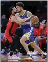  ?? MICHAEL WYKE — THE ASSOCIATED PRESS ?? Rockets guard Fred VanVleet, left, defends as Warriors guard Klay Thompson tries to drive around him during Sunday night's win in Houston.