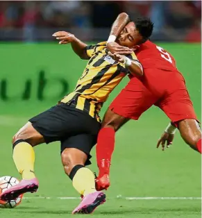  ??  ?? In your face!: Singapore’s Faritz Hameed challenges Malaysia’s Safawi Rasid (left) for the ball in yesterday’s friendly which ended goalless. — Reuters