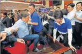  ?? REUTERS ?? Ruling Democratic Progressiv­e Party legislator Chao Tienlin (left) scuffles with opposition legislator­s during a budget meeting for the infrastruc­ture developmen­t programme at the Legislativ­e Yuan in Taipei, Taiwan on Tuesday.