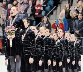  ?? BARRY GRAY HAMILTON SPECTATOR FILE PHOTO ?? Burlington’s NEXXICE team members sing the national anthem after receiving their gold medals before a home crowd at the ISU World Synchroniz­ed Skating Championsh­ip in Hamilton in 2015.