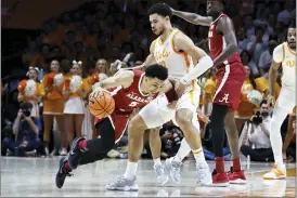  ?? WADE PAYNE — THE ASSOCIATED PRESS ?? Alabama guard Jahvon Quinerly (5) collides with Tennessee forward Olivier Nkamhoua (13) during the first half of Wednesday’s game Wednesday in Knoxville, Tenn.