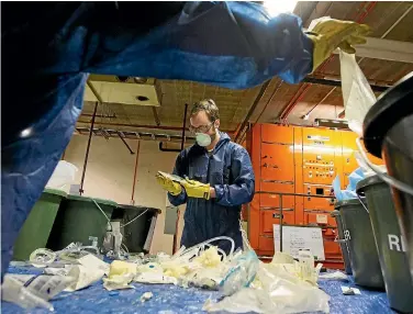  ?? PHOTOS: ROSS GIBLIN/FAIRFAX NZ ?? Thom Adams from the Sustainabi­lilty Trust auditing the waste at Wellington Hospital.