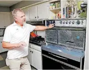  ?? [PHOTO BY NATE BILLINGS, THE OKLAHOMAN ARCHIVES] ?? Michael Hopkins, a collector of mid-century modern items, talks about his Frigidaire Flair Custom Imperial range at his home, 3704 Quapah Circle. Hopkins was vendor at the Mod Swap during Oklahoma Modernism Weekend in June.